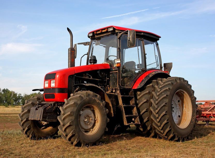 Red Tractor Against the Blue Sky — Thompson's Farm Gear In Taree, NSW