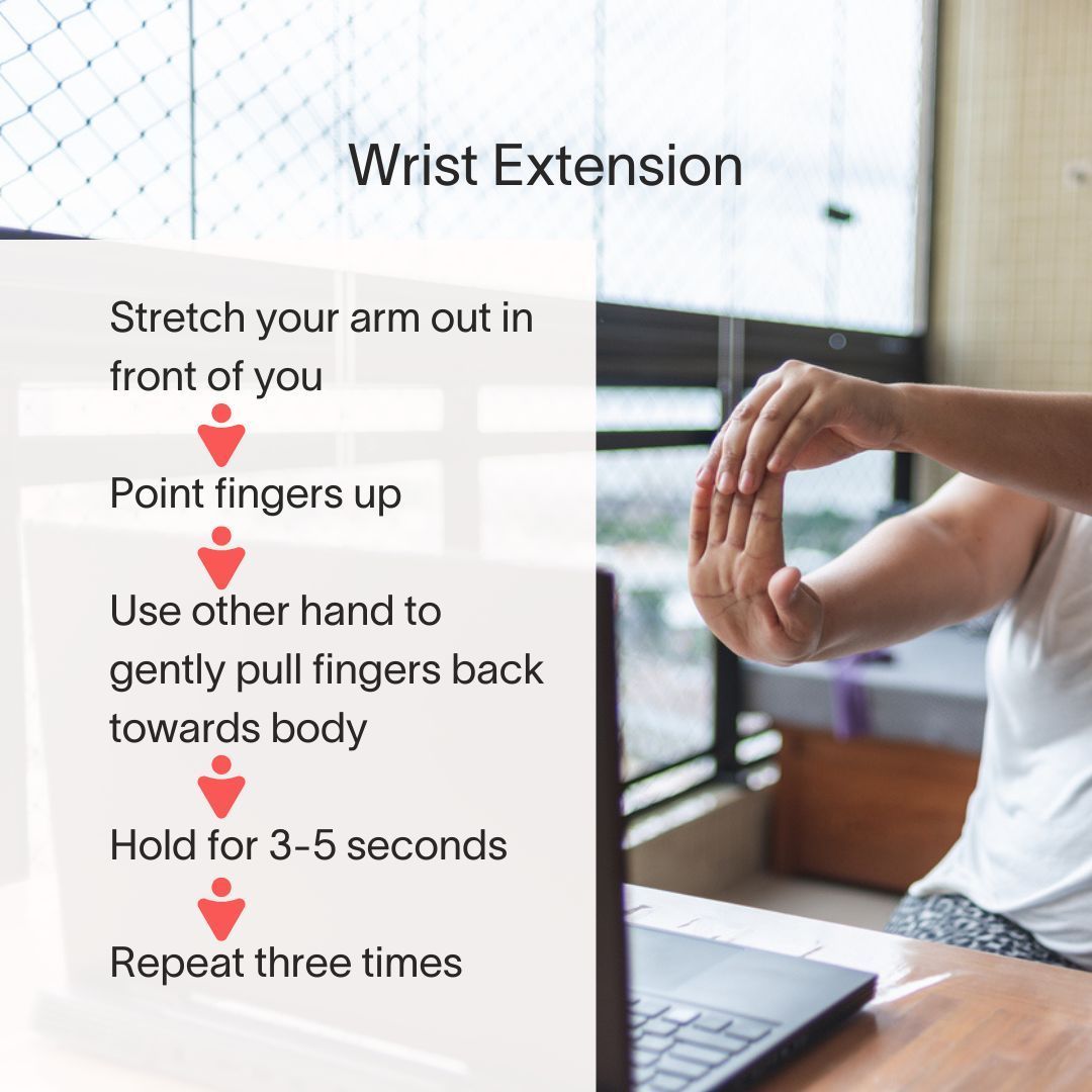 A woman is stretching her arm in front of a laptop computer.