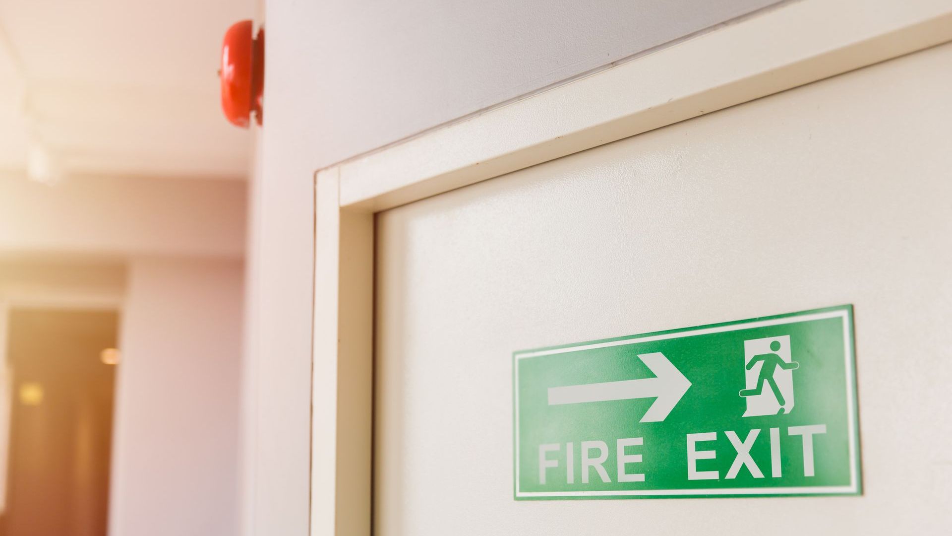 A fire exit sign on a door in a building.