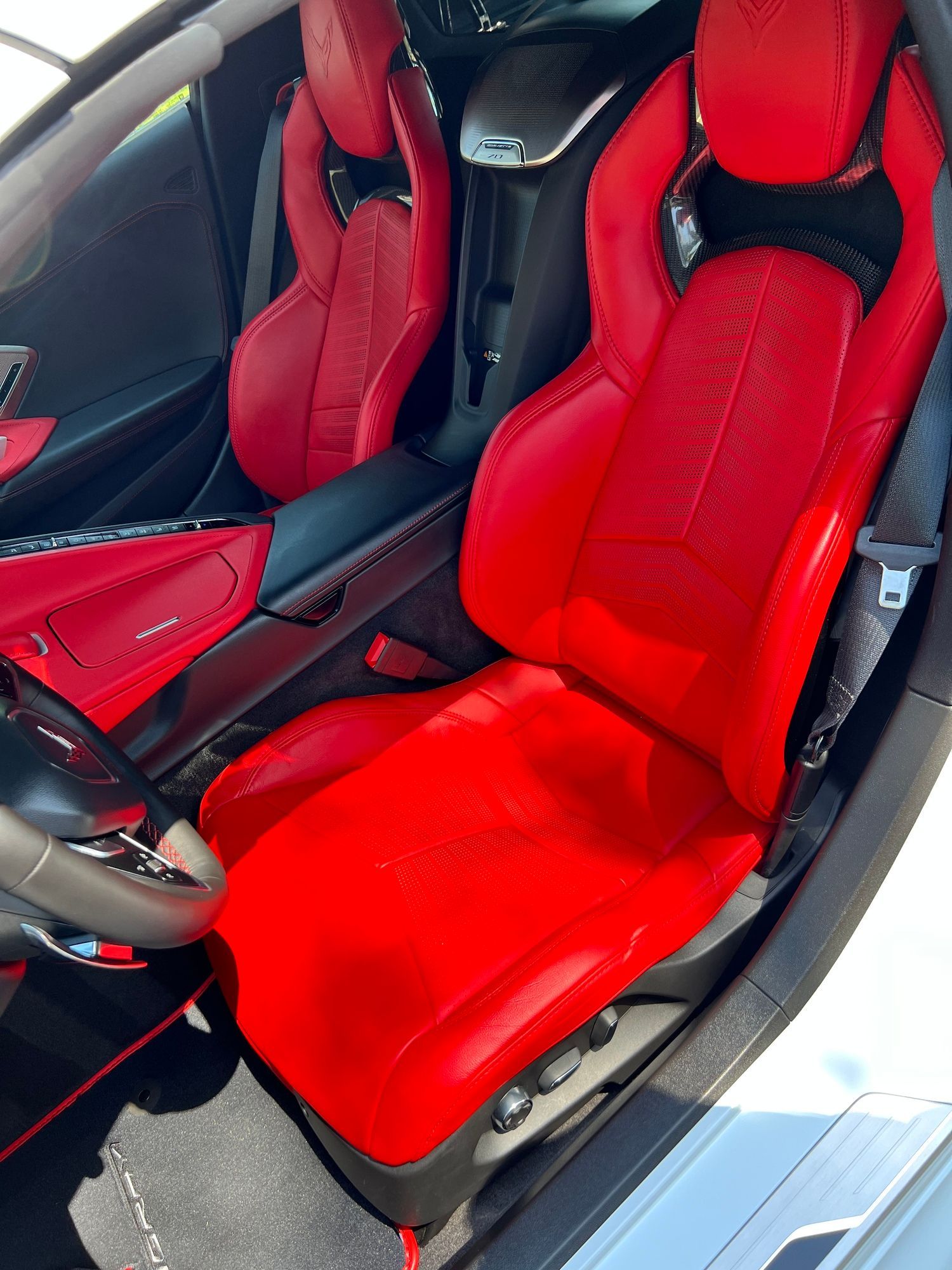DHD Mobile Car Wash- A white sports car with red seats and a steering wheel.