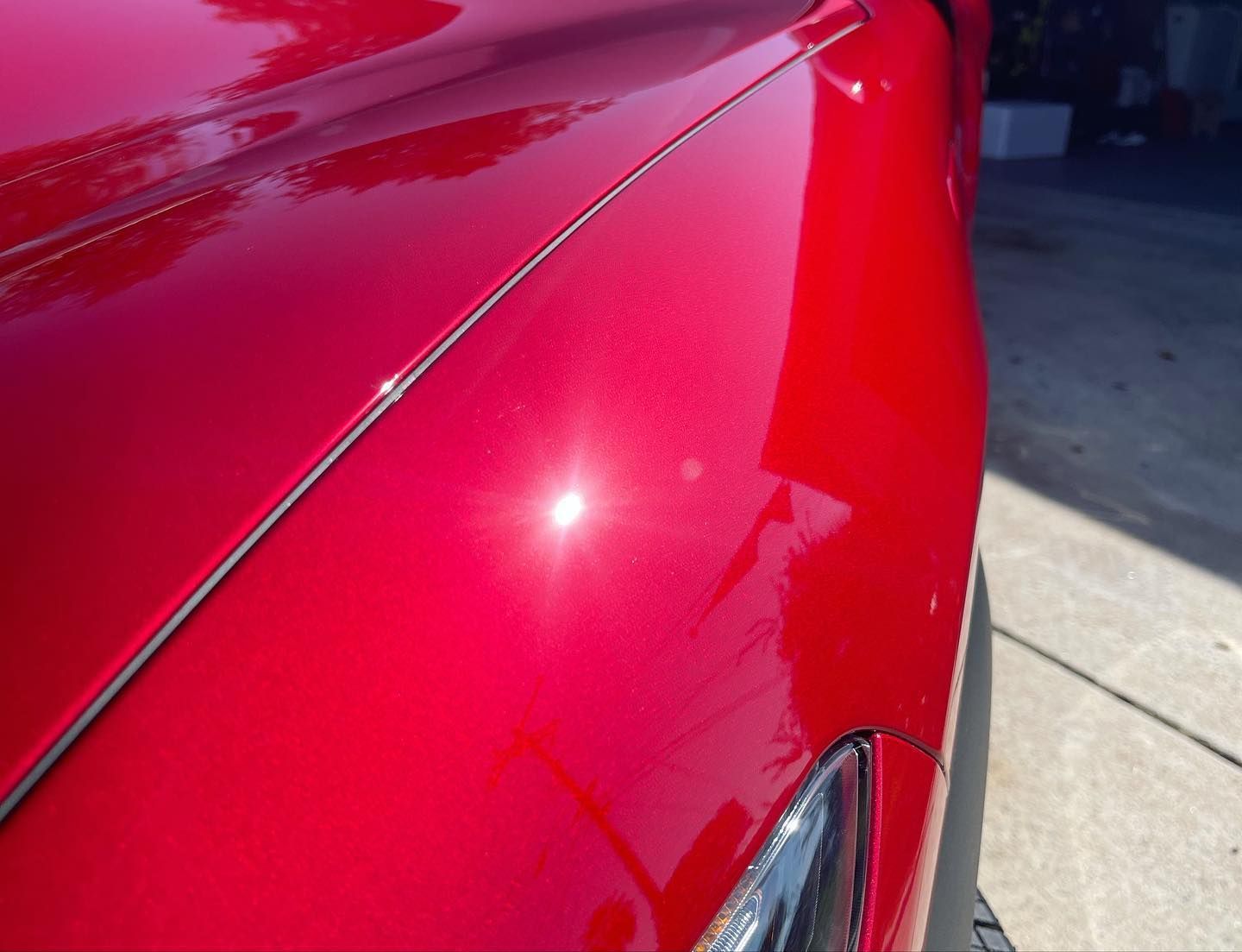 DHD Mobile Car Wash-A close up of a red car parked on the side of the road.