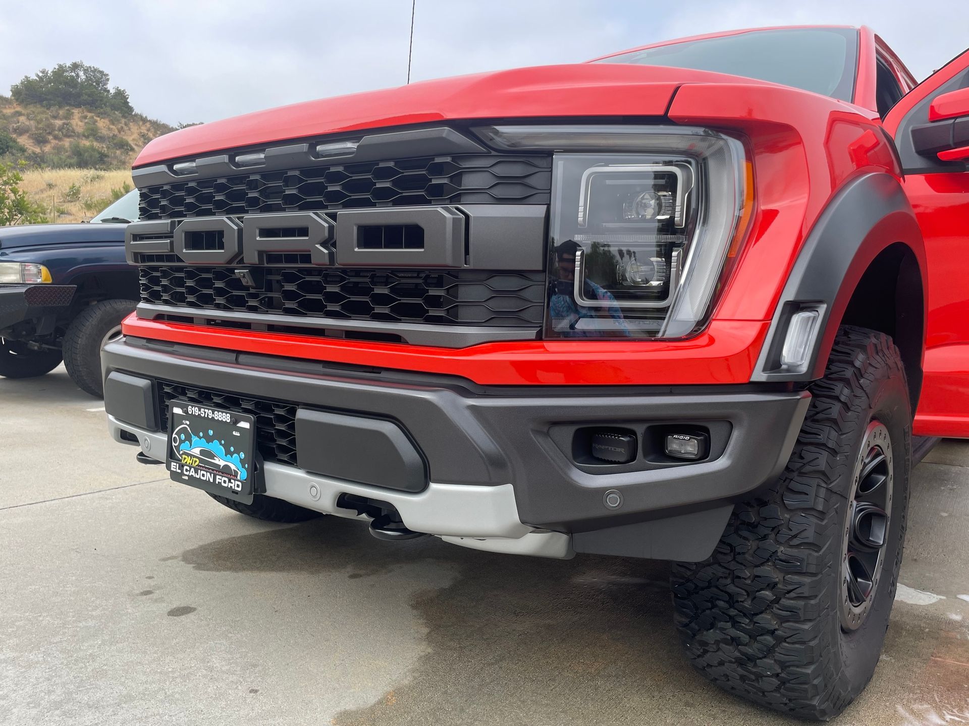 DHD Mobile Car Wash- A red ford raptor truck is parked in a parking lot.