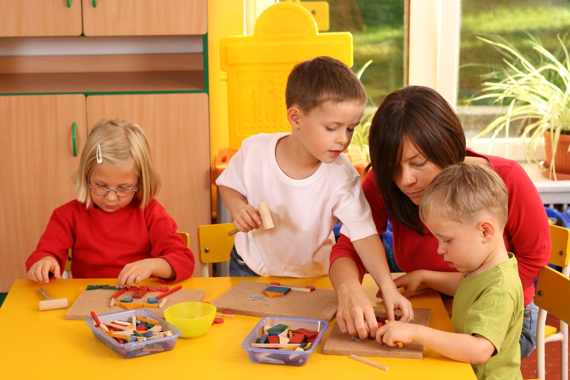 A group of children playing with a teacher