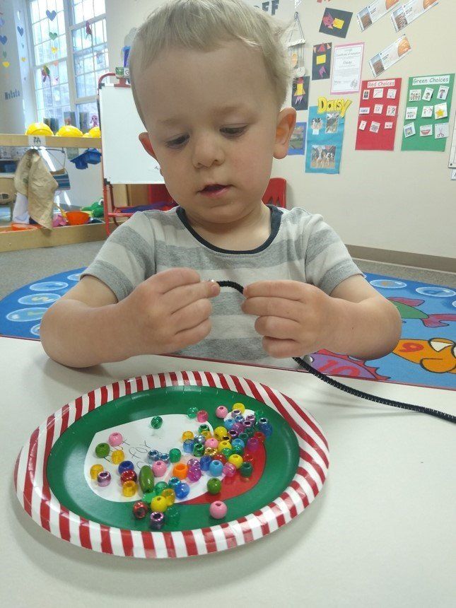 Infant Playing With Beads — Canton, MI — Beginners Inn Childcare & Learning Center