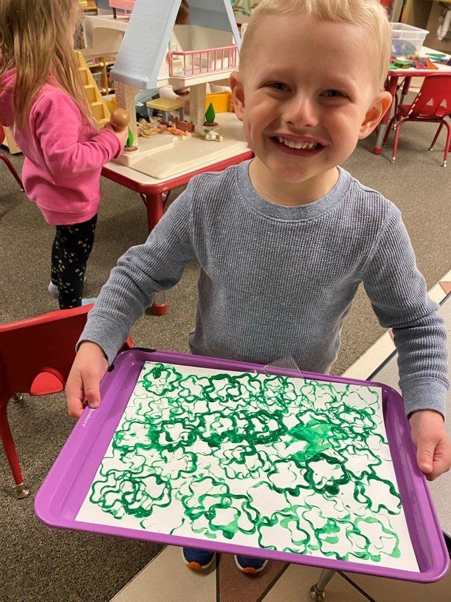 Preschooler Showing His Work — Canton, MI — Beginners Inn Childcare & Learning Center