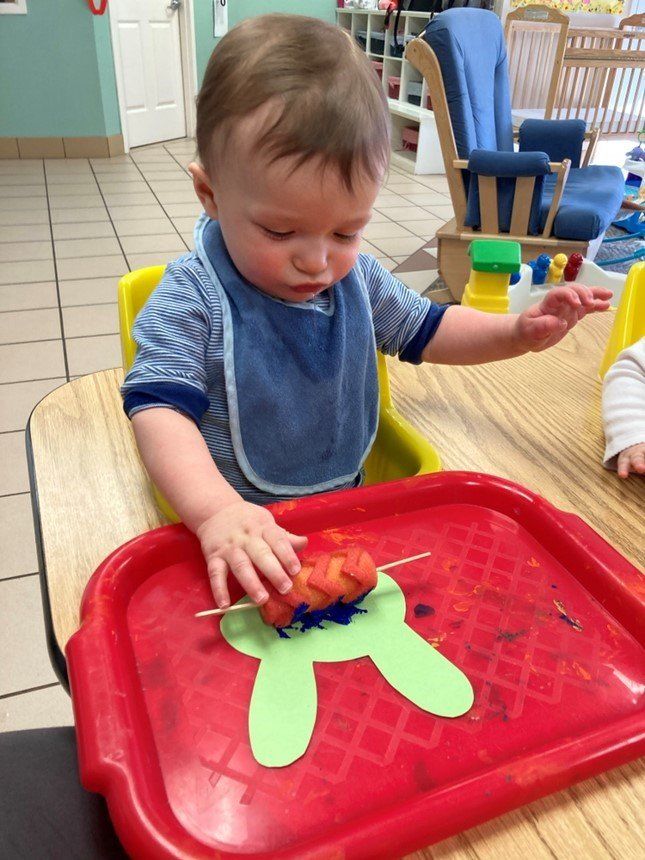 Infant Playing Inside A Classroom — Canton, MI — Beginners Inn Childcare & Learning Center