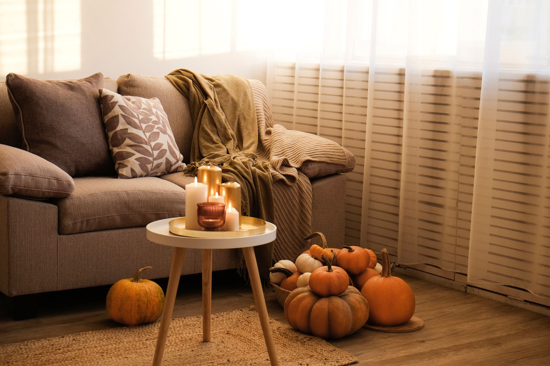 Cozy residential living space with pumpkins and candles for warm seasonal home décor.