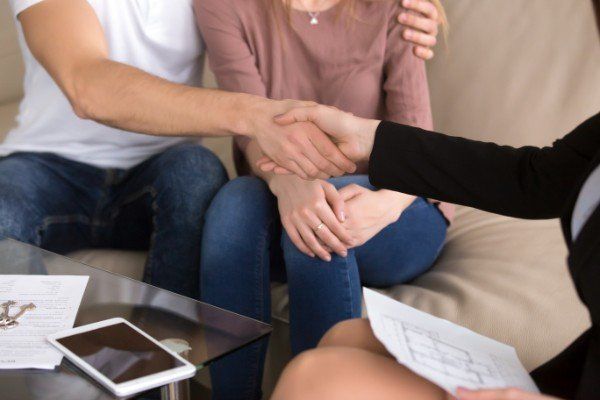 Couple With An Agent Shaking Hands — Cookeville, TN — Buckner Properties