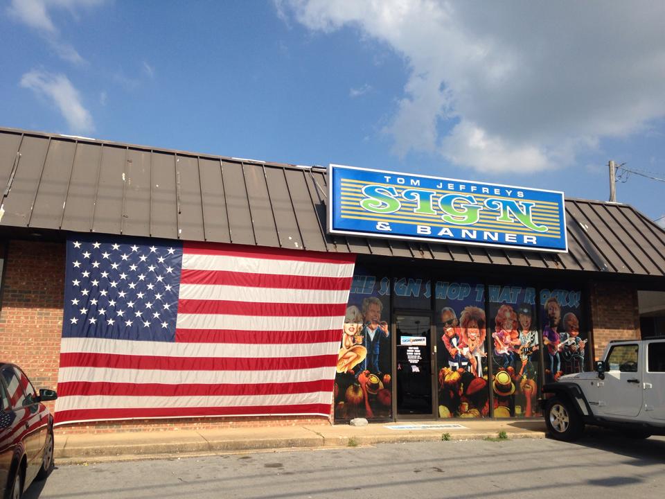 A store front with an american flag in front of it