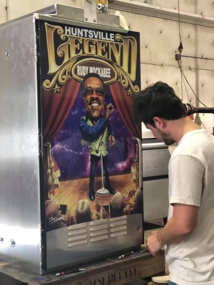 A man is working on a huntsville legend machine