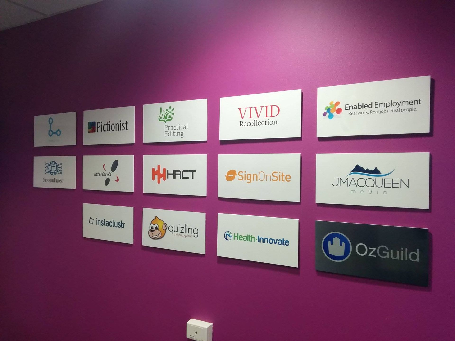 A Purple Wall With a Bunch of Signs on It — Brindabella Print In Fyshwick, ACT