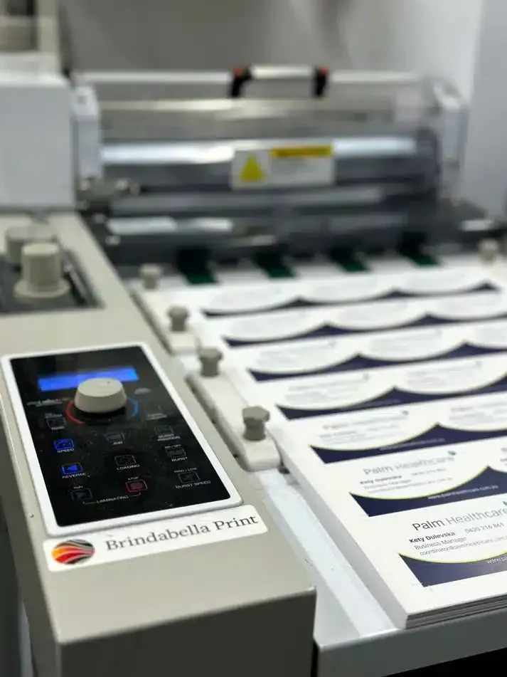 A Machine is Printing Business Cards on a Table — Brindabella Print In Pearce, ACT