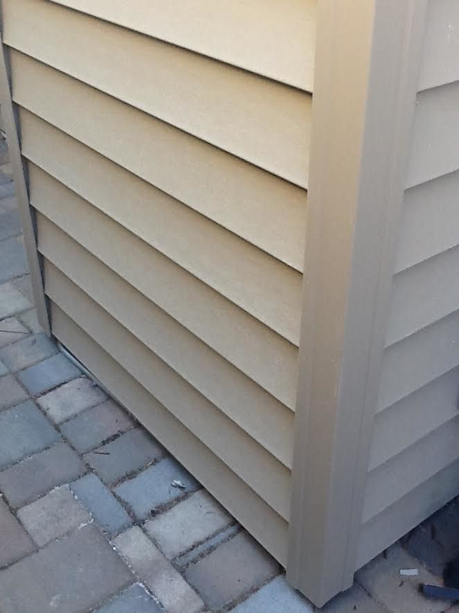 a close up of a beige siding on a building