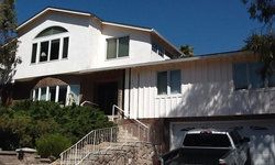 a large white house with a car parked in front of it.