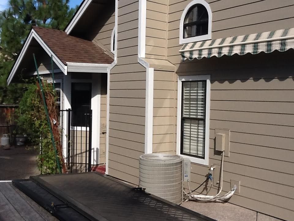 a house with a white awning on the side of it.