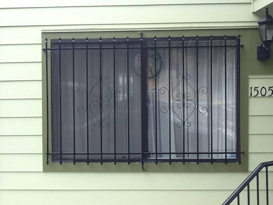 a window with a wrought iron grille on it