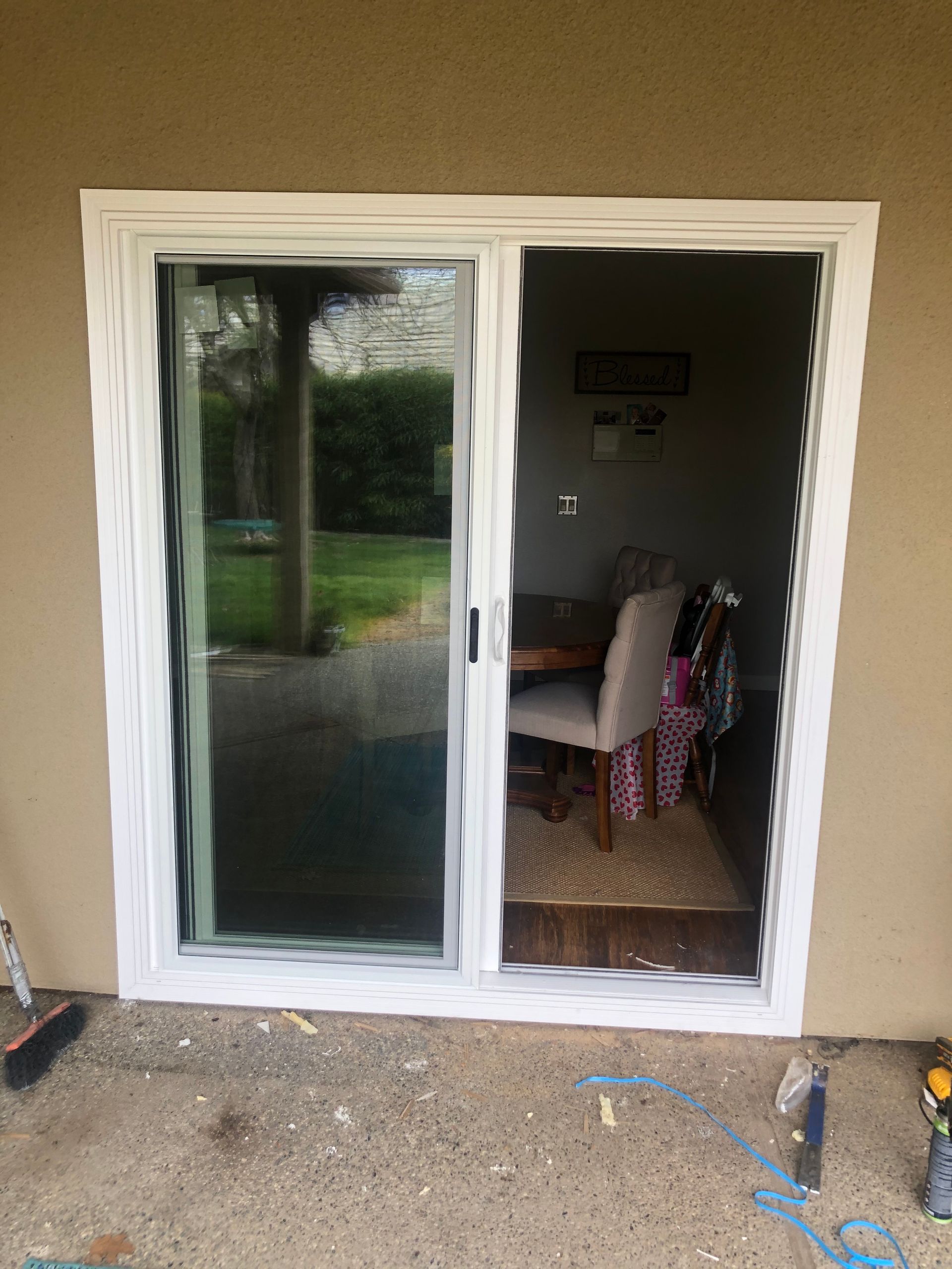 a sliding glass door is open to a dining room.