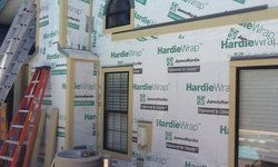 a house is being built with a ladder and a window.