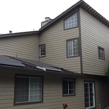 a large house with a lot of windows and a roof.