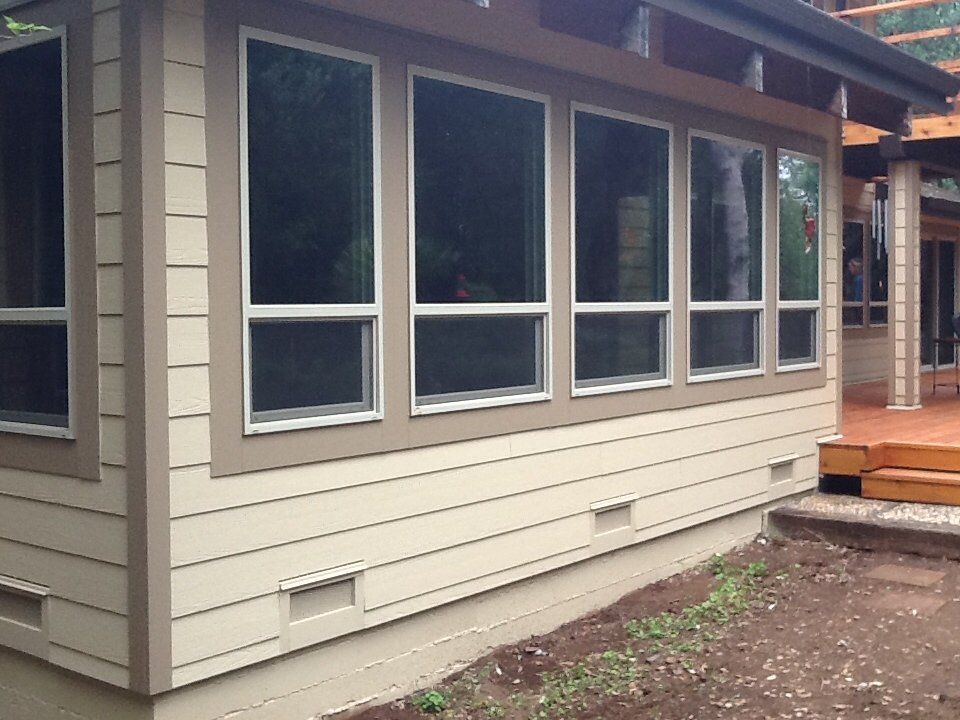 a house with a lot of windows and a deck.