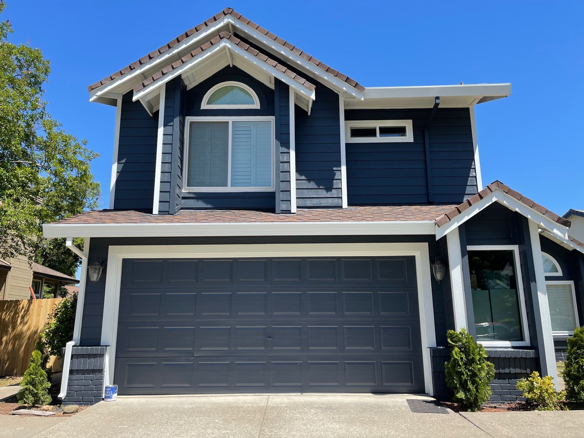 a blue and white house with a large garage door