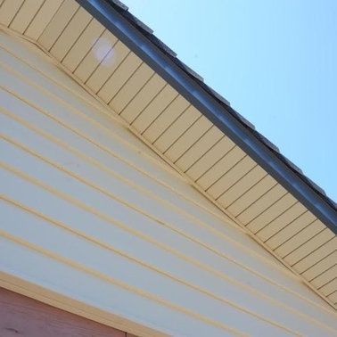 a close up of the roof of a house with a blue sky in the background.
