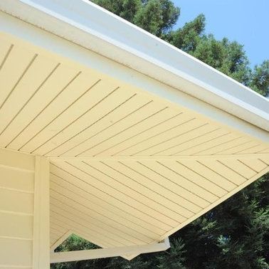 a close up of the ceiling of a house with trees in the background.