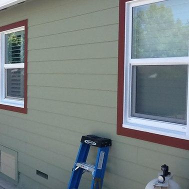 a blue ladder is leaning against the side of a house.