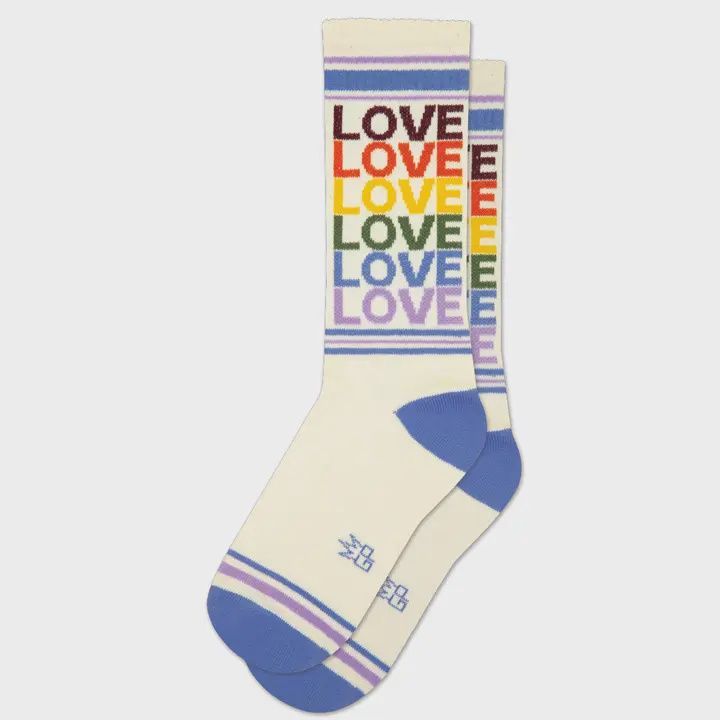 Cream socks with rainbow-striped “LOVE” text and blue heel and toe accents.
