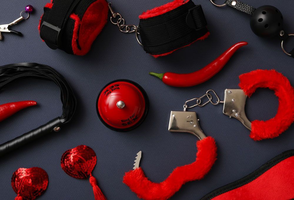 Picture of red bondage items on a gray table