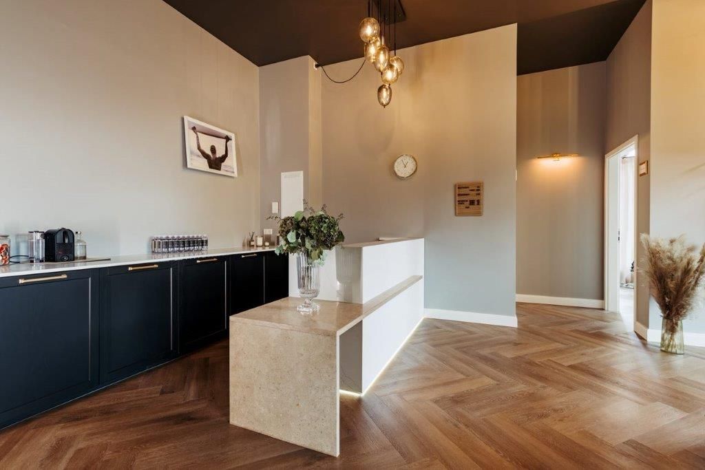 Ein großer Raum mit Holzboden und Rezeptionstresen.