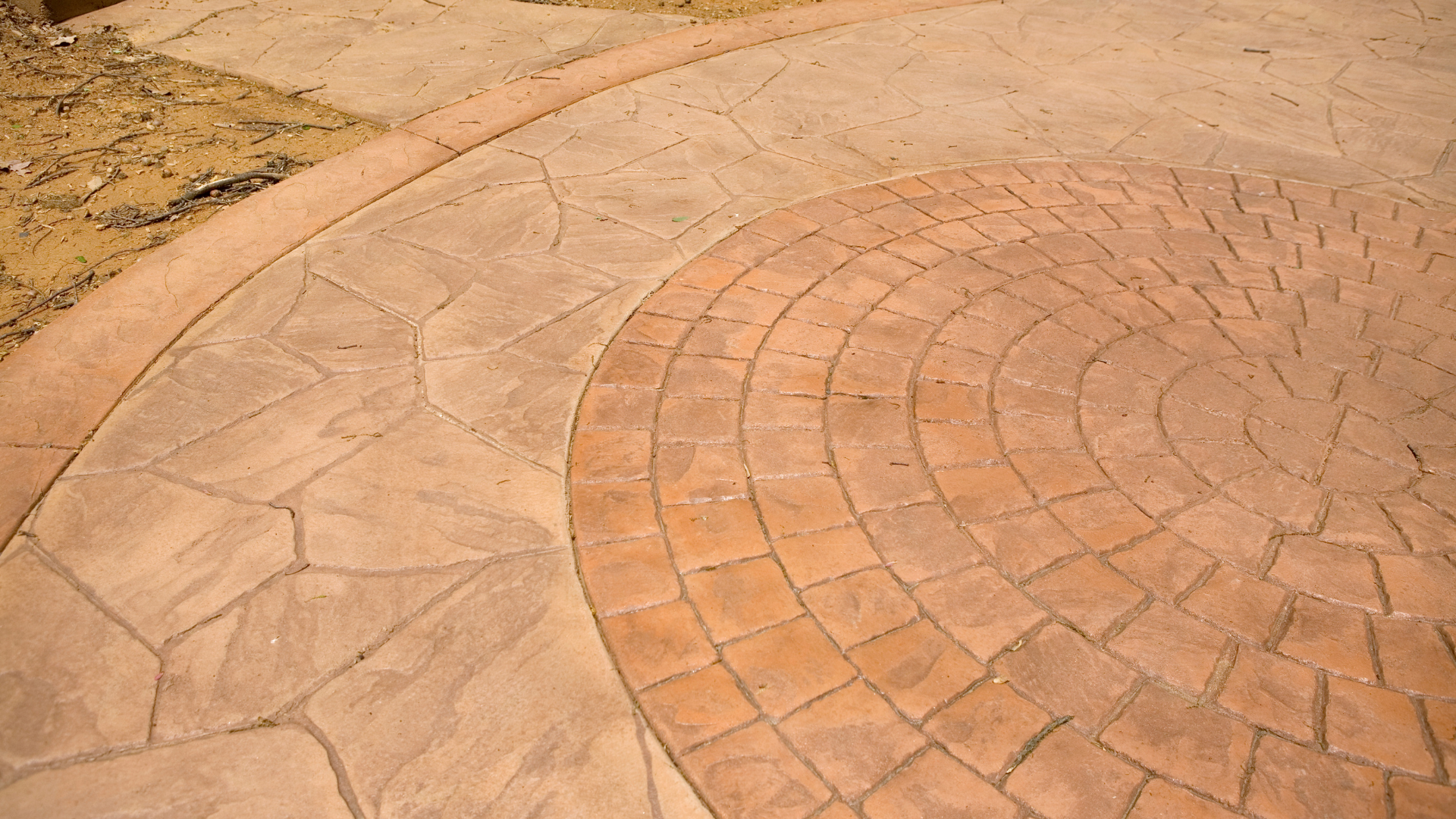 A close up of a brick walkway with a circular pattern.