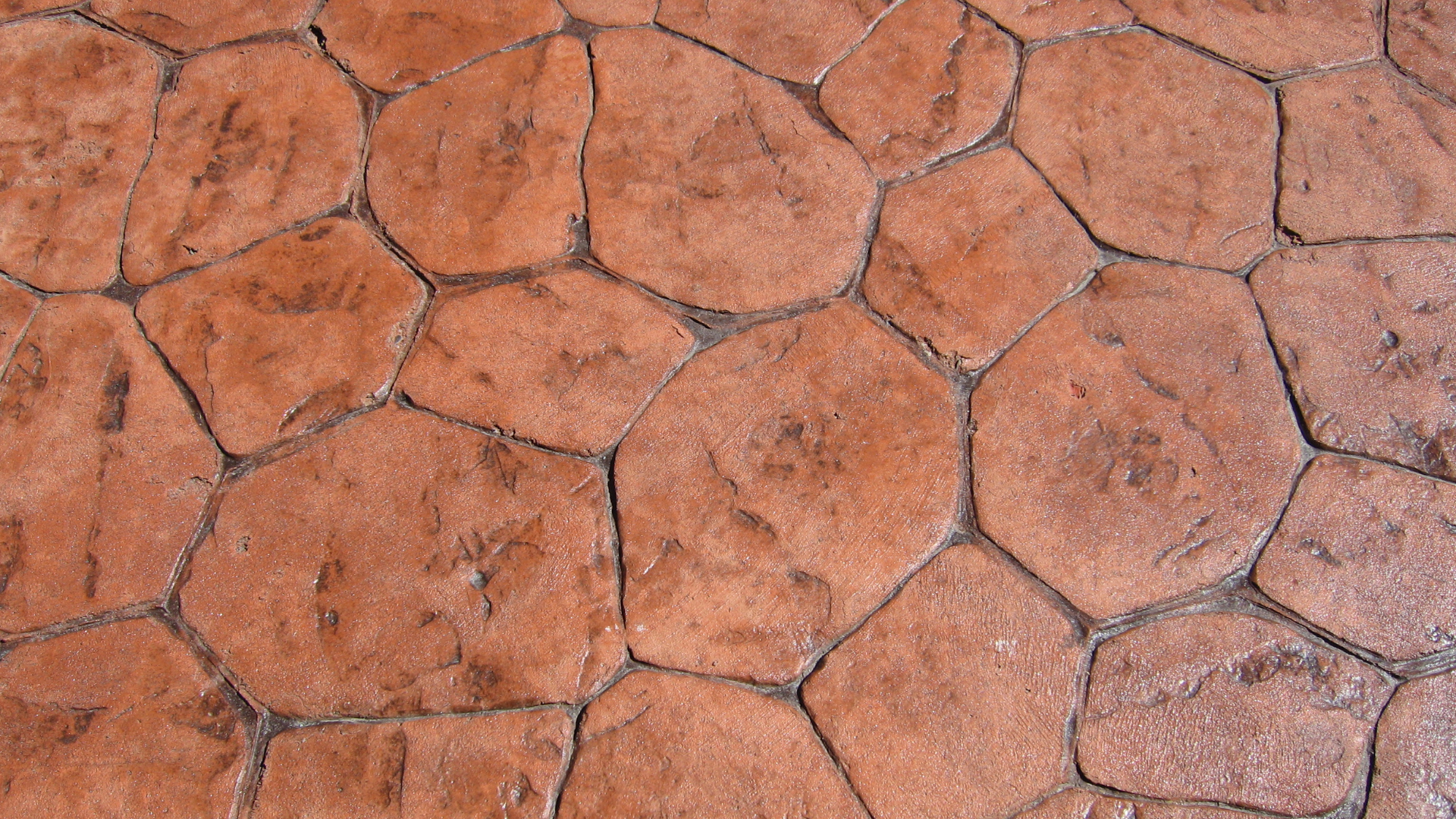 A close up of a brick floor with a geometric pattern