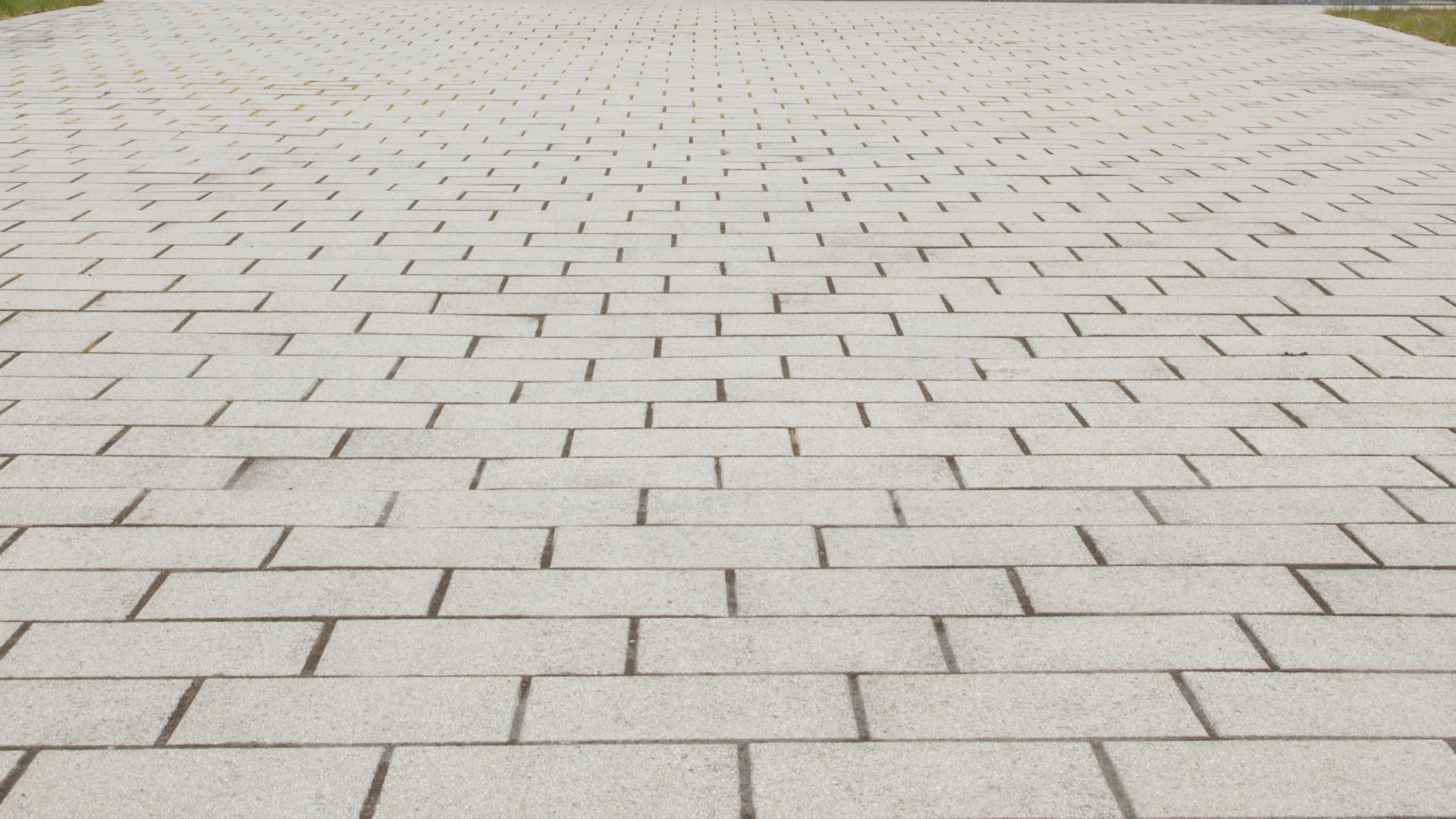A brick walkway with a maze pattern on it