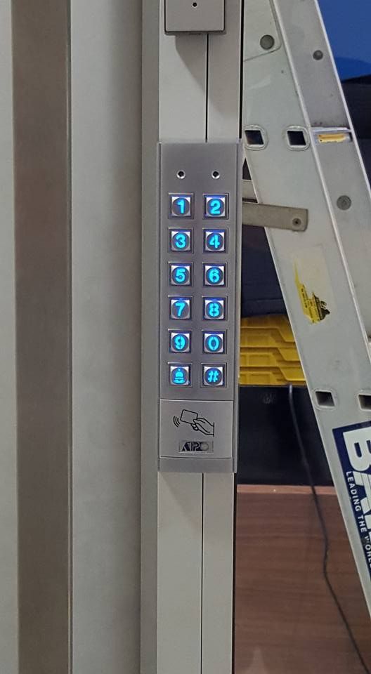 A Ladder Is Sitting Next To A Elevator Control Panel — Fortress Locksmiths & Security in Hornsby, NSW