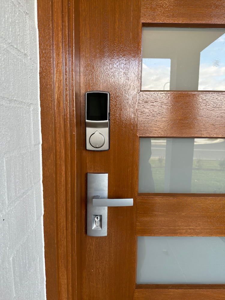 A Wooden Door With A Smart Lock On It — Fortress Locksmiths & Security in Castle Hill, NSW