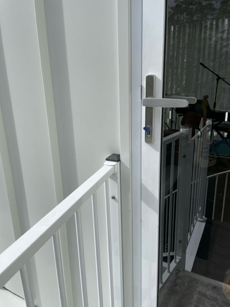 A White Door With A White Railing Is Open To A Balcony — Fortress Locksmiths & Security in Castle Hill, NSW