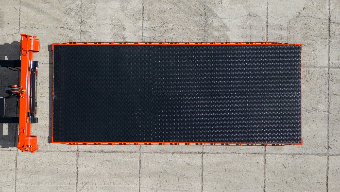 an aerial view of a black and orange mat on a concrete surface .