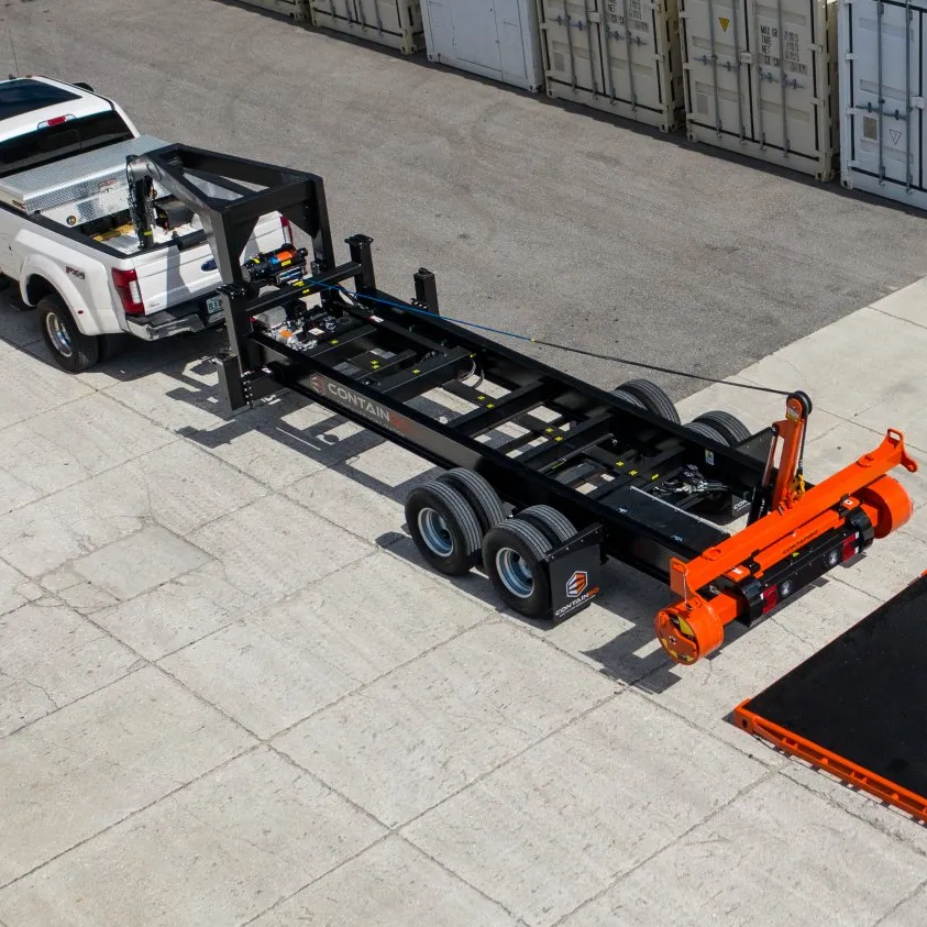 a truck is towing a ContainGo Mobilizer trailer.