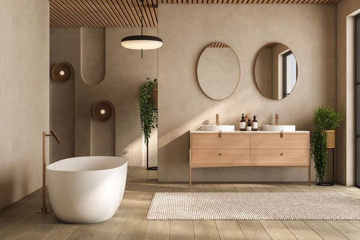 Un bagno sereno e moderno, caratterizzato da una vasca da bagno bianca, un doppio lavabo in legno con specchi circolari e tonalità neutre.