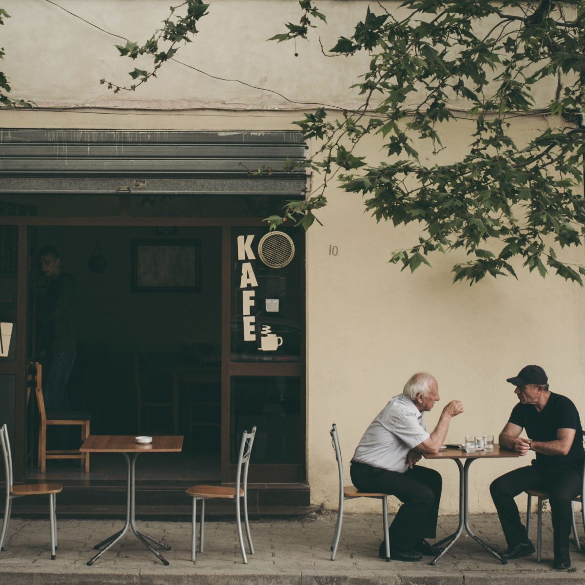 Two men sitting at a cafe