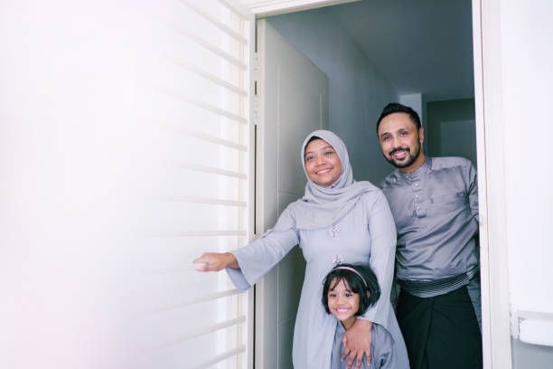 Muslim Family Muslim family standing in doorway smiling