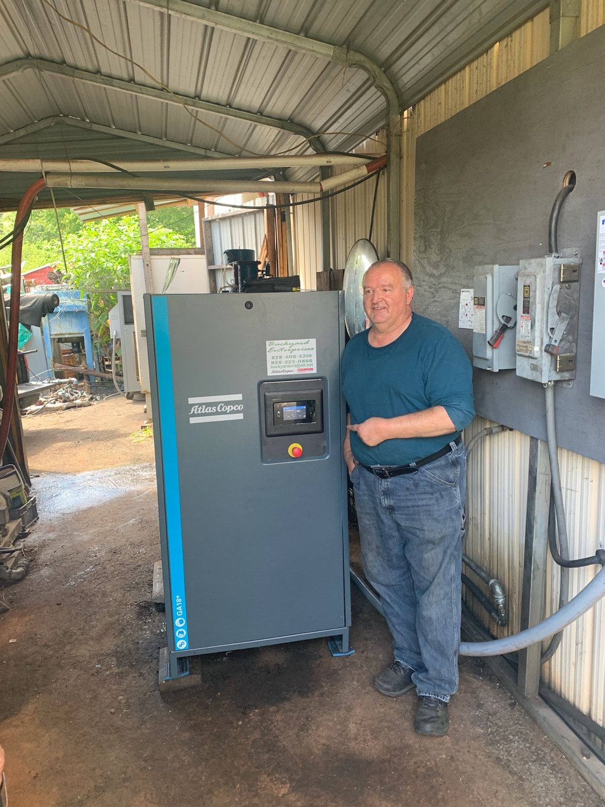 A schulz air compressor is sitting on a blue mat