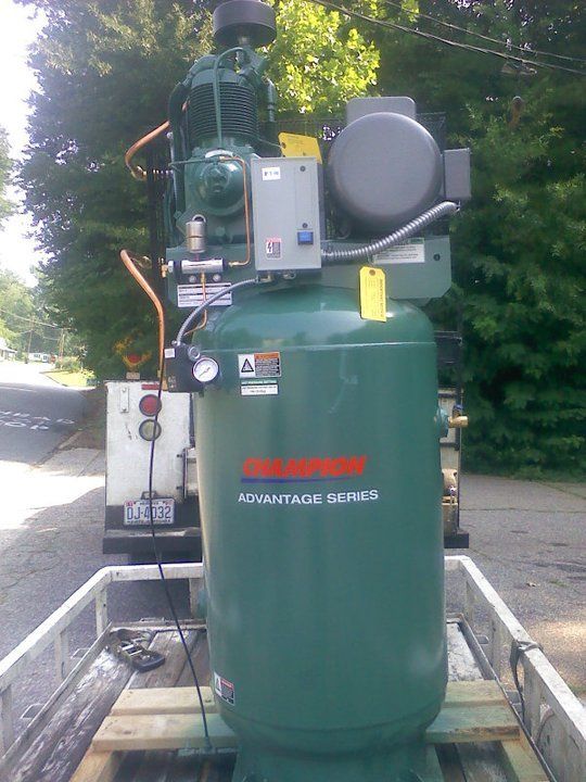 A large green air compressor with the word advantage on it