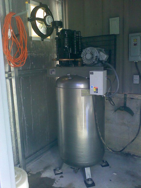 A stainless steel tank with a motor attached to it