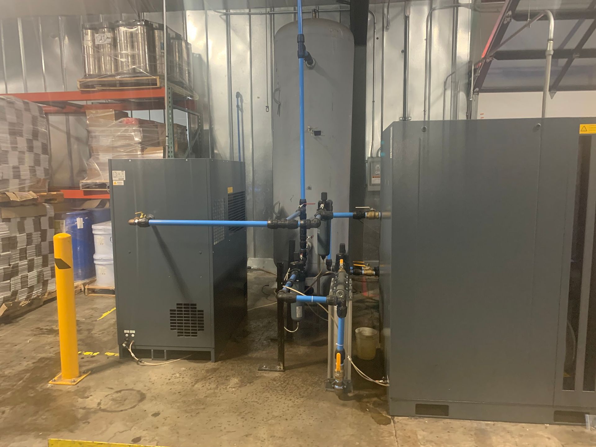 A warehouse with a lot of pipes and machinery in it.