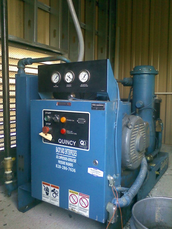 A blue machine with gauges on it is in a room