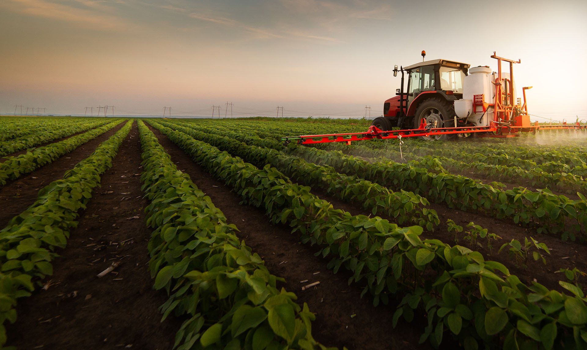 Tractor Spraying Pesticides — Austin, MN — Hoversten, Johnson, Beckmann & Hovey, LLP