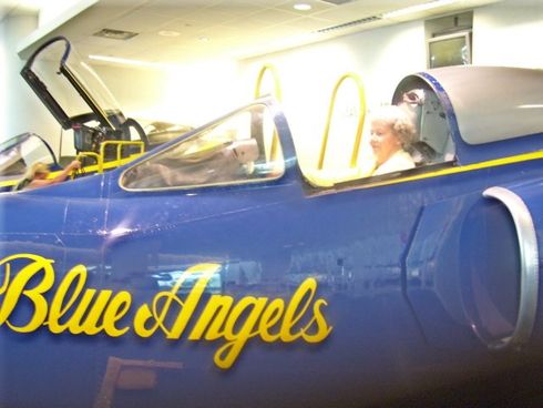 woman in blue angels airplane