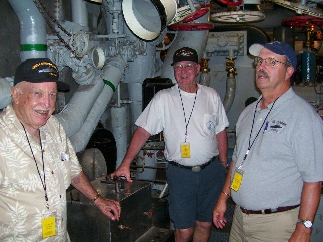 men touring battleship